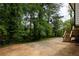 A spacious backyard area offers a private deck overlooking wooded landscaping at 2834 Vicksburg Ct, Decatur, GA 30034