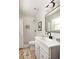 This bathroom features a modern vanity with a black faucet, white tiled shower, and a decorative rug at 2834 Vicksburg Ct, Decatur, GA 30034