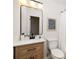 This modern bathroom features an updated vanity with a black faucet, framed mirror, and tiled shower at 2834 Vicksburg Ct, Decatur, GA 30034