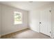 This bedroom has hardwood floors, neutral paint color, a bright window, and a closet with white doors at 2834 Vicksburg Ct, Decatur, GA 30034