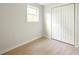 This bedroom features hardwood floors, neutral paint color, and a bright window next to the closet at 2834 Vicksburg Ct, Decatur, GA 30034