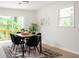 Cozy dining area with modern table, chairs, and a sliding door to the deck at 2834 Vicksburg Ct, Decatur, GA 30034