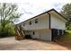 View of the exterior elevation of this home with a two-car garage, private deck, and wooded landscaping at 2834 Vicksburg Ct, Decatur, GA 30034