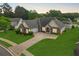 Aerial view of brick home with manicured lawn, driveway and a fenced in backyard at 380 Vista Creek Dr, Stockbridge, GA 30281