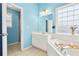 Bright bathroom featuring a large tub, glass block window, and a separate glass enclosed shower at 380 Vista Creek Dr, Stockbridge, GA 30281