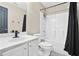 Bathroom featuring a black and white theme, a shower-tub combo, and a single sink vanity at 380 Vista Creek Dr, Stockbridge, GA 30281