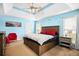 Bright bedroom with tray ceilings, stylish ceiling fan, and coordinated blue walls at 380 Vista Creek Dr, Stockbridge, GA 30281