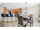 Dining room with an adjacent kitchen featuring a breakfast bar, stainless steel appliances, and a dining table at 380 Vista Creek Dr, Stockbridge, GA 30281