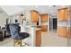 Kitchen featuring counter seating, granite countertops, tile flooring, and wooden cabinets at 380 Vista Creek Dr, Stockbridge, GA 30281