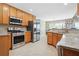 Bright kitchen featuring stainless steel appliances, granite countertops, and tile flooring at 380 Vista Creek Dr, Stockbridge, GA 30281
