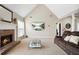 Cozy living room features a brick fireplace, vaulted ceiling, and comfortable seating at 380 Vista Creek Dr, Stockbridge, GA 30281