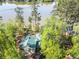 Aerial view of a private home with a green roof surrounded by mature trees, offering seclusion and scenic views at 455 Mayo Rd, Covington, GA 30014
