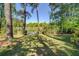 Lush backyard featuring mature trees, a manicured lawn, and direct access to the serene lake at 455 Mayo Rd, Covington, GA 30014