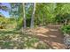 Spacious backyard with landscaping, trees, and a dedicated firepit area, perfect for outdoor gatherings at 455 Mayo Rd, Covington, GA 30014