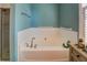 Bathroom featuring a white bathtub, grab bars and tile surround at 455 Mayo Rd, Covington, GA 30014