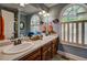 Bathroom featuring a double sink vanity and stained glass windows at 455 Mayo Rd, Covington, GA 30014