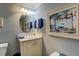 Cozy bathroom with neutral walls, an ornate framed painting, and a modern sink at 455 Mayo Rd, Covington, GA 30014