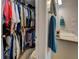 Walk-in closet next to a bathroom with blue towels, providing ample storage space for all your wardrobe needs at 455 Mayo Rd, Covington, GA 30014