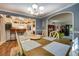 Traditional dining room featuring hardwood floors, an ornate chandelier, and an open-concept view into the kitchen at 455 Mayo Rd, Covington, GA 30014