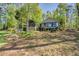 Beautiful home exterior with mature trees, complemented by well-manicured landscaping, creating a peaceful retreat at 455 Mayo Rd, Covington, GA 30014