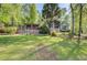 Charming exterior featuring lush landscaping and a screened porch, offering a serene and inviting outdoor space at 455 Mayo Rd, Covington, GA 30014