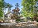 Charming two-story home with a large front yard, three car garage, and beautiful mature trees at 455 Mayo Rd, Covington, GA 30014