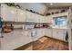 Well-lit kitchen with white cabinets and wood-look flooring at 455 Mayo Rd, Covington, GA 30014