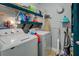 Functional laundry room with a modern washer and dryer and shelving for storage at 455 Mayo Rd, Covington, GA 30014