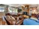 Cozy living room with a stone fireplace, comfortable leather furniture, and a large window at 455 Mayo Rd, Covington, GA 30014