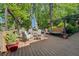Expansive wooden deck with dining and seating areas, ideal for lakefront entertaining at 455 Mayo Rd, Covington, GA 30014