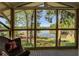 Bright screened-in porch offering stunning views of the lake and lush greenery at 455 Mayo Rd, Covington, GA 30014