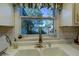 Kitchen sink overlooking serene lake views and a neutral-colored tile backsplash at 455 Mayo Rd, Covington, GA 30014