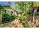 Stone walkway to home with garden, stone retaining wall, and mature landscape at 455 Mayo Rd, Covington, GA 30014