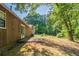 The backyard is spacious and features a patio and mature trees at 5326 Rocky Pine Dr, Lithonia, GA 30038