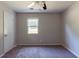 This carpeted bedroom features neutral walls and a window letting in natural light at 5326 Rocky Pine Dr, Lithonia, GA 30038