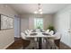 Dining area features modern lighting, large windows, and a door to the backyard at 5326 Rocky Pine Dr, Lithonia, GA 30038