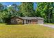 Charming single-story home features a brick facade, an attached garage, and a well-maintained lawn at 5326 Rocky Pine Dr, Lithonia, GA 30038