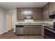 This kitchen features stainless steel appliances, dark wood cabinets, and great countertop space at 5326 Rocky Pine Dr, Lithonia, GA 30038