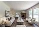 Staged living room area with fireplace, lots of seating, and natural light from the large windows at 5326 Rocky Pine Dr, Lithonia, GA 30038