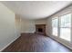Spacious living room features a brick fireplace and lots of natural light from the large windows at 5326 Rocky Pine Dr, Lithonia, GA 30038