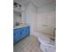 Full bathroom view with blue vanity, toilet, and tub at 589 Catrina Ct, Stone Mountain, GA 30087