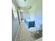 Modest bathroom with single sink, blue vanity and a toilet near the doorway at 589 Catrina Ct, Stone Mountain, GA 30087