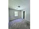 Cozy carpeted bedroom with a closet and two windows that bring in plenty of natural light at 589 Catrina Ct, Stone Mountain, GA 30087