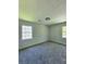 Carpeted bedroom with a view from the windows, neutral walls, and ceiling light fixture at 589 Catrina Ct, Stone Mountain, GA 30087