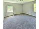 Spacious bedroom with carpeted floors and natural light coming through two large windows at 589 Catrina Ct, Stone Mountain, GA 30087