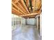 Unfinished garage with exposed wood framing and a white garage door at 589 Catrina Ct, Stone Mountain, GA 30087