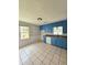 Kitchen features tile floors, blue cabinets, and bright window at 589 Catrina Ct, Stone Mountain, GA 30087