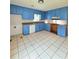 Kitchen features tile floors and ample blue cabinetry at 589 Catrina Ct, Stone Mountain, GA 30087