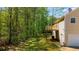 Spacious backyard with mature trees, deck, and rear home elevation at 379 Villa Rosa Way, Temple, GA 30179