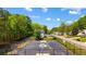 Outdoor basketball court with a sturdy black fence, surrounded by vibrant trees and neighboring homes in a Gathering friendly area at 379 Villa Rosa Way, Temple, GA 30179